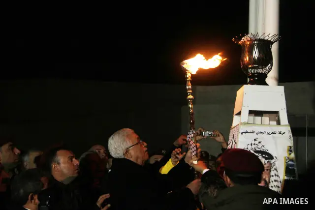 Palestinian president Mahmoud Abbas lights a flame to mark the 47th anniversary of Palestinian revolution and the establishing of Fatah movement, in the West Bank city of Ramallah on December 31, 2011. Photo by Issam Rim...