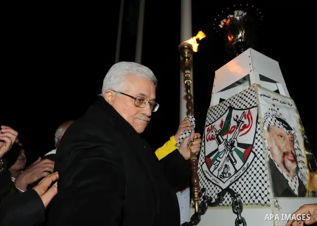 Palestinian president Mahmoud Abbas lights a flame to mark the 47th anniversary of Palestinian revolution and the establishing of Fatah movement, in the West Bank city of Ramallah on December 31, 2011. Photo by Mufeed Ab...