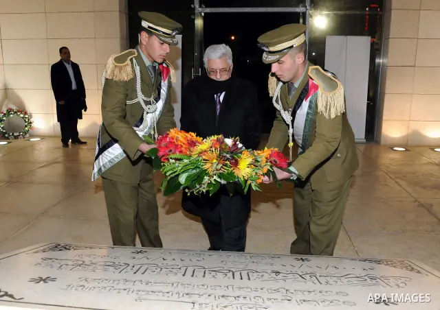 Palestinian leader Mahmud Abbas lays a wreath at the tomb of late leader Yasser Arafat during mark the 47th anniversary of Palestinian revolution and the establishing of Fatah movement, in the West Bank city of Ramallah...