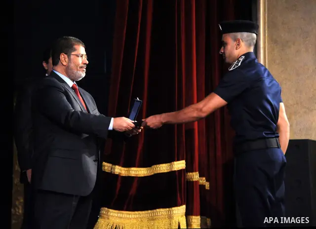 In this image released by the Egyptian Presidency, Egyptian President, Mohammed Morsi at a graduation ceremony at the Police Academy headquarters in Cairo, Egypt, July 14, 2012. The Police Academy was also the venue for...