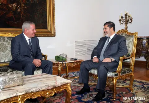 Egypt's President Mohamed Mursi (R) meets with Egypt's newly appointed Minister of State for Military Production Reda Mahmoud Hafez Abdel Maguid at the presidential palace in Cairo, August 13, 2012. Mursi has driven back...