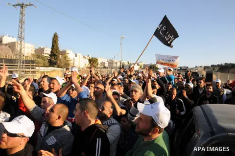 Palestinians take part in a protest against the opening project of the street number (4) in the middle of Bet Safafa neighbourhood, which is for settlement project services, in Jerusalem on February 26, 2013. Photo by Ma...