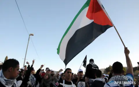 Palestinians take part in a protest against the opening project of the street number (4) in the middle of Bet Safafa neighbourhood, which is for settlement project services, in Jerusalem on February 26, 2013. Photo by Ma...
