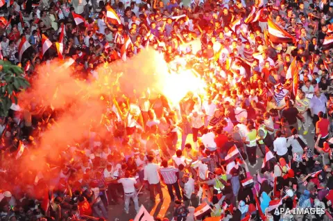 Opponents of Egypt's Islamist President Mohammed Morsi light flares during a protest at Tahrir Square in Cairo July 2, 2013. With the clock ticking, Egypt's besieged president said Tuesday that he will not step down as s...