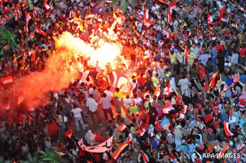 Opponents of Egypt's Islamist President Mohammed Morsi light flares during a protest at Tahrir Square in Cairo July 2, 2013. With the clock ticking, Egypt's besieged president said Tuesday that he will not step down as s...