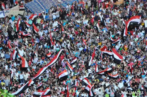 Fireworks light the sky as opponents of Egypt's Islamist President Mohammed Morsi protest in Tahrir square, in Cairo, Egypt, Tuesday, July 2, 2013. With the clock ticking, Egypt's besieged president said Tuesday that he...