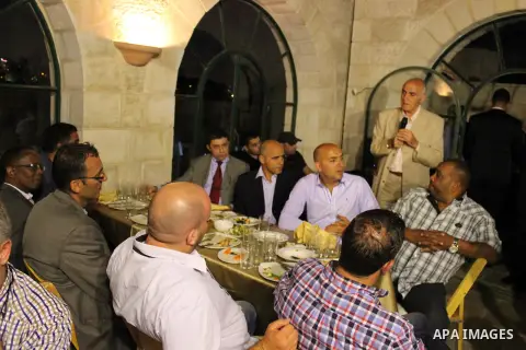 Palestinians of the National and religious leaders, Muslim and Christian attend the collective Iftar 'the evening meal during the Islamic month of Ramadan' to break their fasting in the Old City of Jerusalem, 16 July 201...