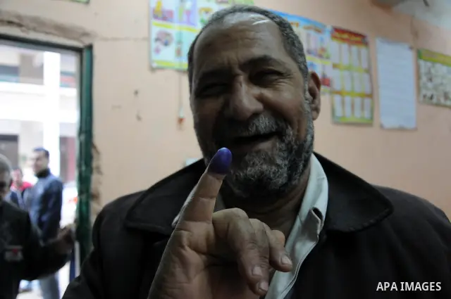 An Egyptian man shows her ink marked finger after casting her vote during the second day of the third round of the elections for Egypt's parliament, in Egypt, Wednesday, Jan. 4, 2012. Egyptians are voting in the final ro...