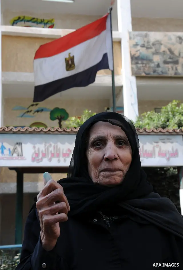 A veiled Egyptian woman shows her ink-stained finger after voting outside a polling station in Qaliubia, some 40 kms north of Cairo, on January 4, 2012 as Egyptians headed to the polls again in the final round of a phase...