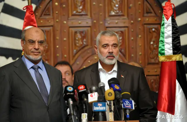 Tunisia's Prime Minister Hamadi Jbeli (R) speaks with senior Palestinian prime minister in gaza strip, Ismail Haniyeh, in Tunis January 5, 2012. Photo by Mohammed Al-Ostaz