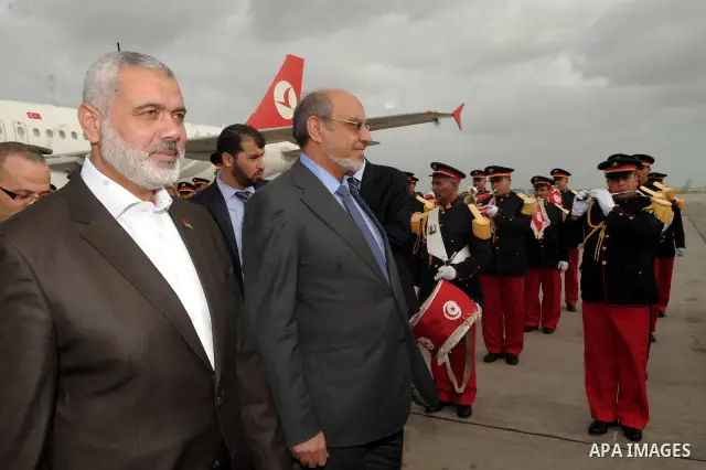 Tunisia's Prime Minister Hamadi Jbeli (R) speaks with senior Palestinian prime minister in gaza strip, Ismail Haniyeh, in Tunis January 5, 2012. Photo by Mohammed Al-Ostaz