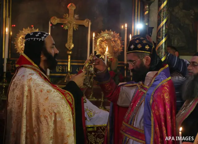 Greek Orthodox priests attend the Christmas procession inside the Church of the Nativity in the West Bank town of Bethlehem January 6, 2012. Photo by Issam Rimawi