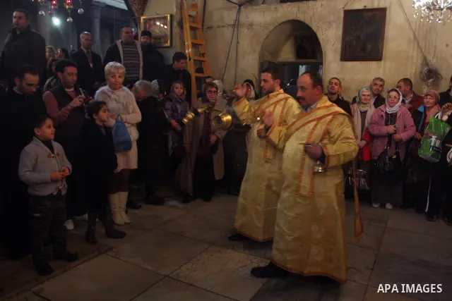 Greek Orthodox priests attend the Christmas procession inside the Church of the Nativity in the West Bank town of Bethlehem January 6, 2012. Photo by Issam Rimawi