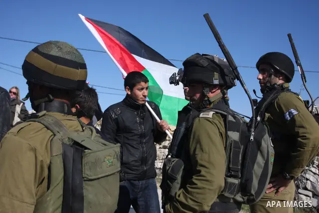 Israeli soldiers stand face-to-face with Palestinian during a demonstration against Israel's controversial separation barrier in the village of Maasarah, near the biblical West Bank city of Bethlehem, Friday, Jan. 6, 201...