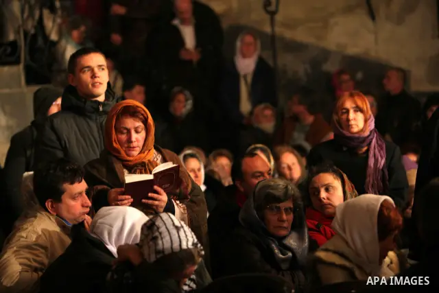 An Orthodox worshipper cries inside the Church of the Nativity, traditionally believed by Christians to be the birthplace of Jesus Christ, during Orthodox Christmas celebrations in the West Bank city of Bethlehem, late F...