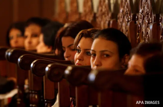 Palestinian Greek Orthodox Christians attend Christmas mass at the Orthodox Saint Porfirios church in Gaza City on January 7, 2012. The Orthodox Church celebrates Christmas and other religious holidays according to the J...