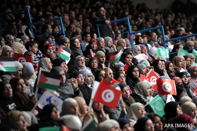 Tunisian Islamist Ennahdha Party supporters cheer as they greet of Palestinian Prime Minister in gaza strip, Ismail Haniya on January 7, 2012 in Tunis. Photo by Mohammed Al-Ostaz
