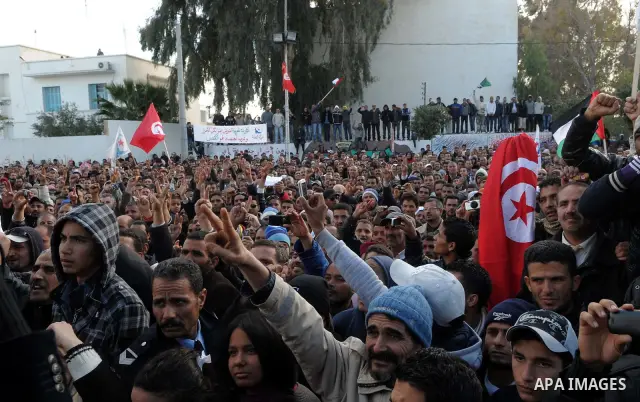 Tunisian Islamist Ennahdha Party supporters cheer as they greet of Palestinian Prime Minister in gaza strip, Ismail Haniya on January 7, 2012 in Tunis. Photo by Mohammed Al-Ostaz