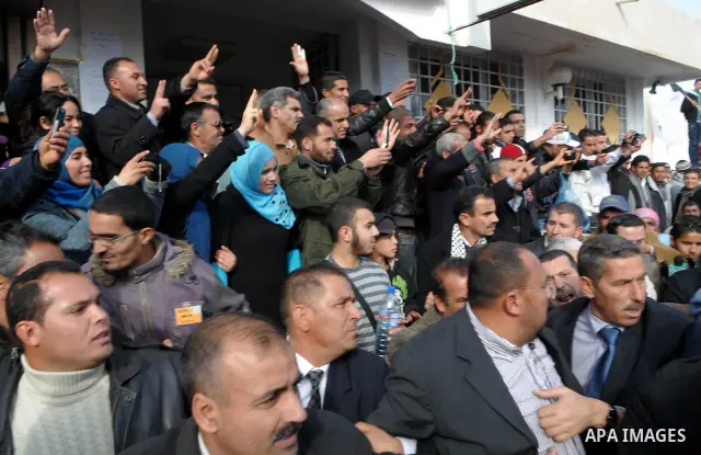 Tunisian Islamist Ennahdha Party supporters cheer as they greet of Palestinian Prime Minister in gaza strip, Ismail Haniya on January 7, 2012 in Tunis. Photo by Mohammed Al-Ostaz