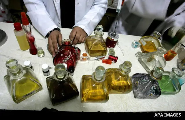 Palestinian women stand behind a counter in a small laboratory manufacturing perfumes to sell locally in the Rafah refugee camp in the southern Gaza Strip on January 8, 2012. A report released in October 2011 by the Worl...