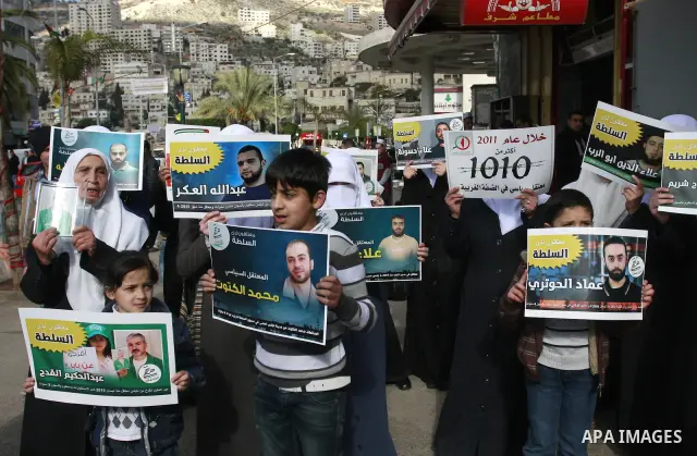 Palestinian Hamas supporters hold up pictures of relatives who were arrested and imprisoned for political reasons by Palestinian Authority security forces, during a protest in the West Bank city of Nablus, on Jan. 09, 20...