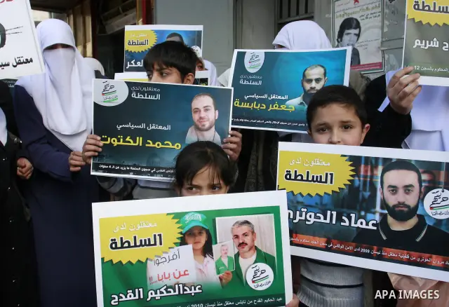 Palestinian Hamas supporters hold up pictures of relatives who were arrested and imprisoned for political reasons by Palestinian Authority security forces, during a protest in the West Bank city of Nablus, on Jan. 09, 20...