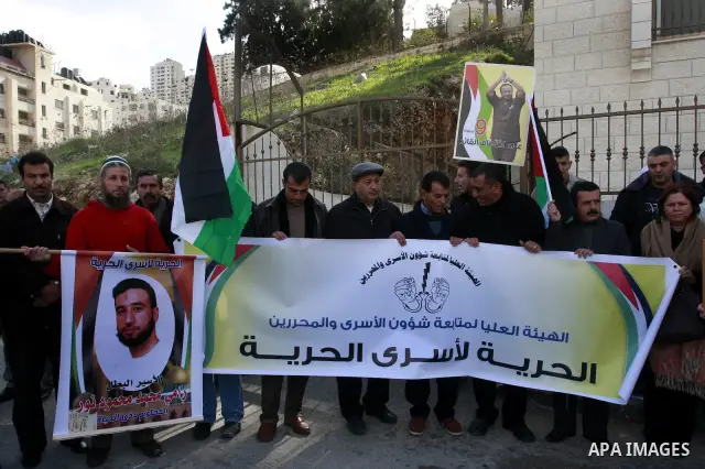 Palestinians hold up pictures of relatives held in Israeli jails during a protest calling for their release, in the West Bank city of Nablus, Wednesday,Jan.11, 2012. Photo by Wagdi Eshtayah