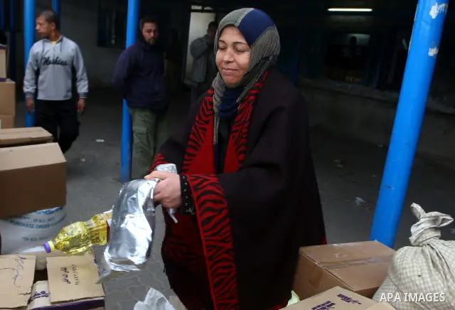 Palestinians receive their monthly food aid at a UN distribution center in the Shati refugee camp, in Gaza City, on January 17, 2012. The UN Agency for Palestinian Refugees (UNRWA) in Gaza launched an appeal for emergenc...