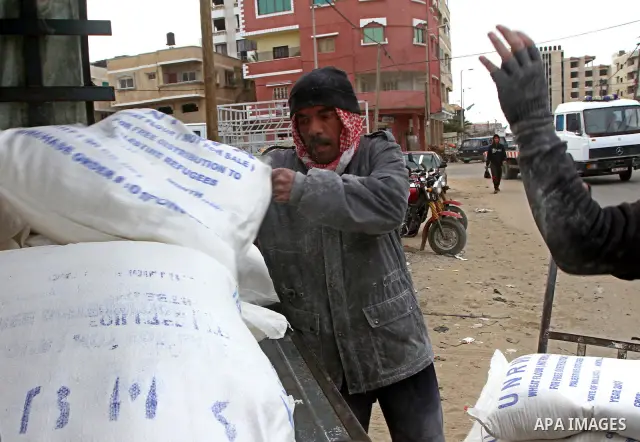 Palestinians receive their monthly food aid at a UN distribution center in the Shati refugee camp, in Gaza City, on January 17, 2012. The UN Agency for Palestinian Refugees (UNRWA) in Gaza launched an appeal for emergenc...