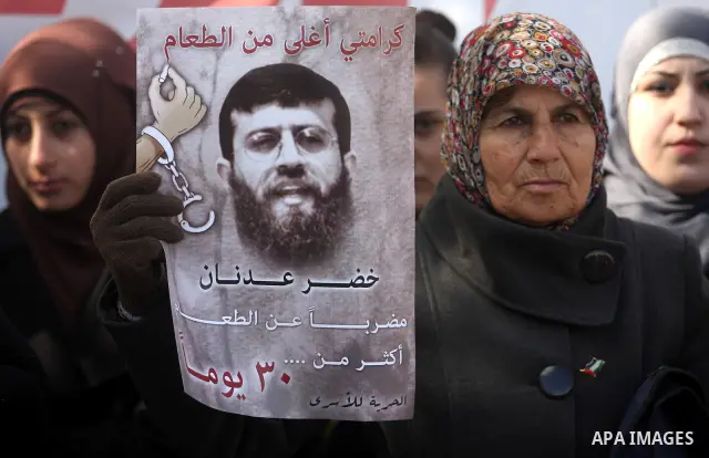 Palestinians hold portraits of relatives, held in Israeli jails, during a protest calling for their release, in the West Bank city of Ramallah, Tuesday, Jan. 17, 2012. Israel currently holds about 6,000 Palestinians in i...