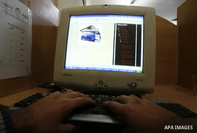 Palestinian man uses a computer as he looks at Visa cards on the web site in the southern Gaza Strip on January 18, 2012. The attacks were launched against Israeli sites at the beginning of this month when a Saudi intern...