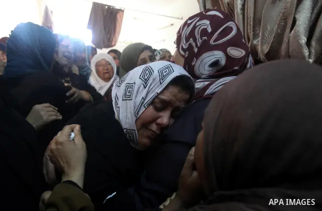 Palestinian women mourn the body of Mohamed Abu Awda at his house, after he was killed in an Israeli airstrike on northern Gaza on January 18, 2012. The raid hit a field used by Hamas in the east of the northern town Bei...