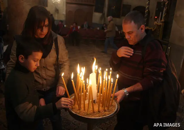 Christians light candles during celebration during an Armenian Christmas procession in the Church of the Nativity in West Bank city of Bethlehem, Wednesday, Jan. 18, 2012. The Armenian Orthodox church in the Holy Land ce...