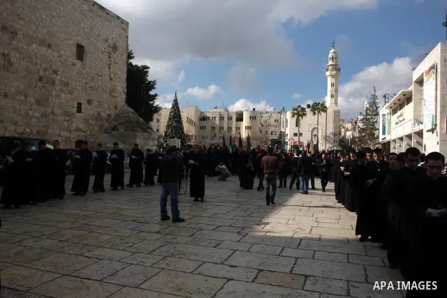 Christians celebrate during an Armenian Christmas procession through Manger Square to the Church of the Nativity in West Bank city of Bethlehem, Wednesday, Jan. 18, 2012. The Armenian Orthodox church in the Holy Land cel...