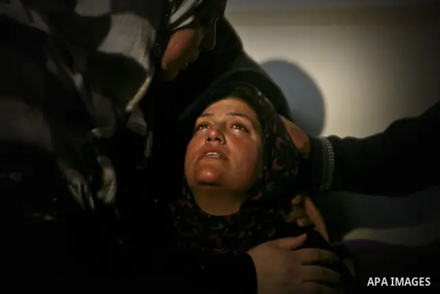 Palestinians mourn the body of Mohamed Abu Awda at his house, after he was killed in an Israeli airstrike on northern Gaza on January 18, 2012. The raid hit a field used by Hamas in the east of the northern town Beit Han...