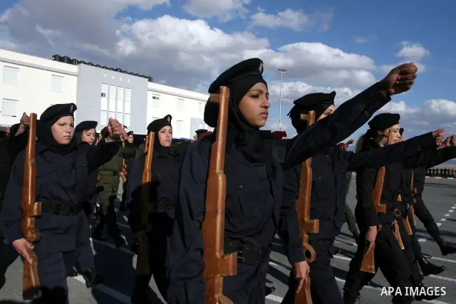 Palestinian female security forces loyal to Palestinian President Mahmoud Abbas march with mock weapons during a graduation ceremony in the West Bank city of Jericho, Thursday, Jan. 19, 2012. Photo by Issam Rimawi