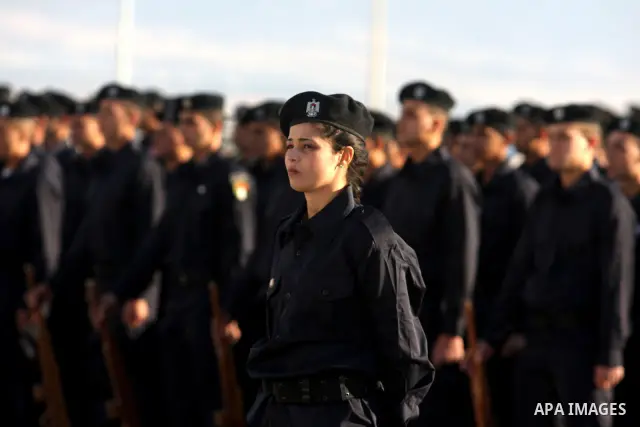 Palestinian security forces loyal to Palestinian President Mahmoud Abbas march with mock weapons during a graduation ceremony in the West Bank city of Jericho, Thursday, Jan. 19, 2012. Photo by Issam Rimawi