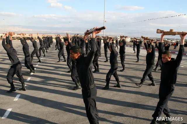 Palestinian security forces loyal to Palestinian President Mahmoud Abbas demonstrate their skills during a graduation ceremony in the West Bank city of Jericho, Thursday, Jan. 19, 2012. Photo by Issam Rimawi