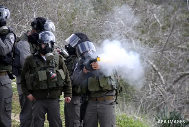 Israeli border officers clash with Palestinian demonstrators during a protest in the village of Kufr Qaddum, near the Israeli settlement of Kdumim, in the northern West Bank, Friday, Jan. 20, 2012. Photo by Wagdi Eshtaya...