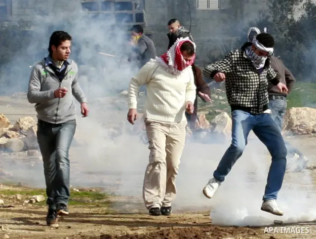 Israeli border officers clash with Palestinian demonstrators during a protest in the village of Kufr Qaddum, near the Israeli settlement of Kdumim, in the northern West Bank, Friday, Jan. 20, 2012. Photo by Wagdi Eshtaya...