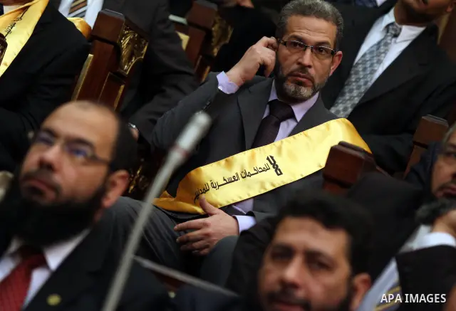 A member of the Egyptian parliament wears a banner reading "No to military trials" as parliament members attend the first Egyptian parliament session after the revolution that ousted former President Hosni Mubarak, in Ca...