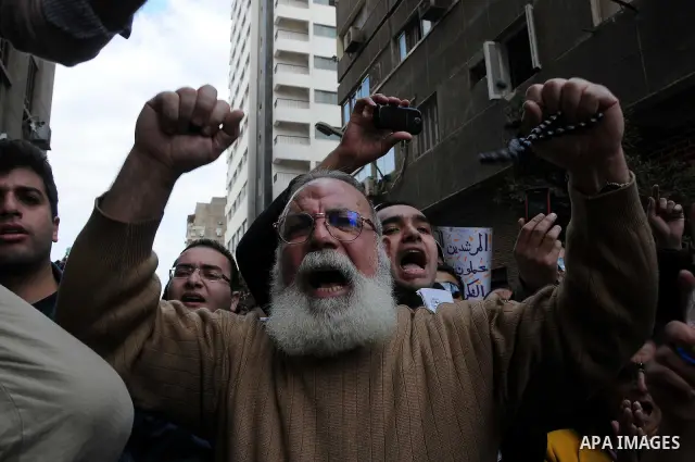 Egyptians gather outside the parliament during the first parliament session after the revolution that ousted former President Hosni Mubarak, in Cairo January 23, 2012. Egypt's parliament began its first session on Monday...
