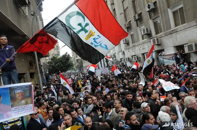Egyptians gather outside the parliament during the first parliament session after the revolution that ousted former President Hosni Mubarak, in Cairo January 23, 2012. Egypt's parliament began its first session on Monday...