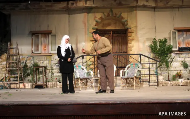 Palestinian artists perform a play during a celebration organized by Women's Affairs Centre in the occasion of the Women's Inheritance Day at al-Shawwa theatre, in Gaza City, on Jan. 24, 2012. Photo by Mohammed Asad