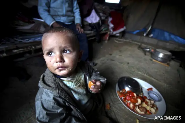 Palestinian children gather at their makeshift tent in one of the poorest regions in the Al-Zaiton neighbourhood, in the Gaza strip, on 24 January 2012. With high rates of unemployment and lack of work opportunities in G...