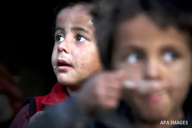 Palestinian children gather at their makeshift tent in one of the poorest regions in the Al-Zaiton neighbourhood, in the Gaza strip, on 24 January 2012. With high rates of unemployment and lack of work opportunities in G...