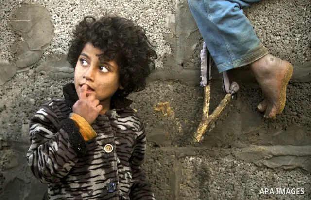 Palestinian children play between makeshift tents in one of the poorest regions in the Al-Zaiton neighbourhood, in the Gaza strip, on 24 January 2012. With high rates of unemployment and lack of work opportunities in Gaz...