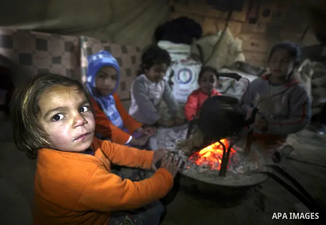 Palestinian children gather at their makeshift tent in one of the poorest regions in the Al-Zaiton neighbourhood, in the Gaza strip, on 24 January 2012. With high rates of unemployment and lack of work opportunities in G...