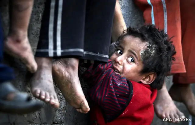 Palestinian children play between makeshift tents in one of the poorest regions in the Al-Zaiton neighbourhood, in the Gaza strip, on 24 January 2012. With high rates of unemployment and lack of work opportunities in Gaz...