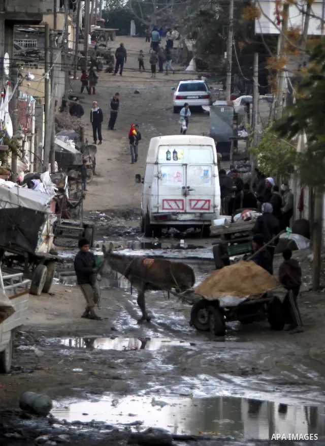 Palestinians gather in a road in one of the poorest regions in the Al-Zaiton neighbourhood, in the Gaza strip, on 24 January 2012. With high rates of unemployment and lack of work opportunities in Gaza, an increasing num...